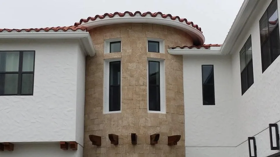 Curved stone turret white fascia gutter clay tile roof, Sanford